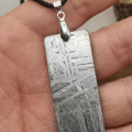 Silver Tipped Meteorite Necklace Silver tipped meteorite necklace with a meteorite pendant