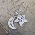 Moon and star personalised necklace shown in a lifestyle setting