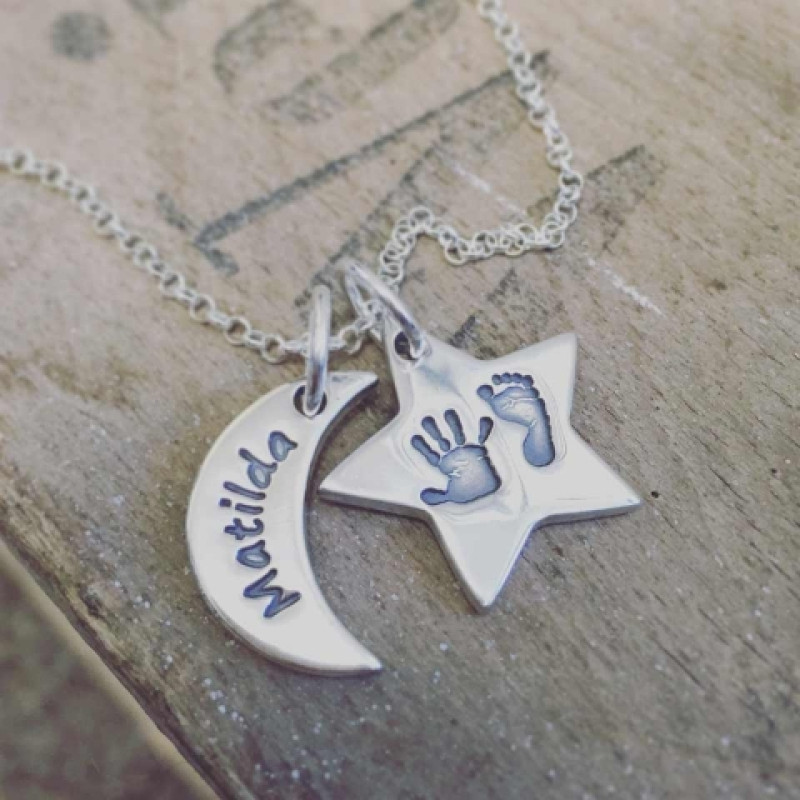 Moon and star personalised necklace shown in a lifestyle setting