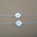 Dainty sunflower bracelet with a yellow gold-coloured centre on a silver chain