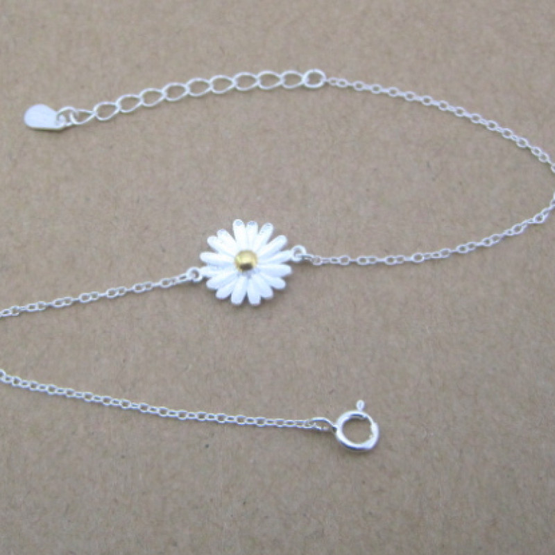 Dainty sunflower bracelet with a yellow gold-coloured centre on a silver chain