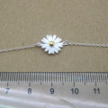 Dainty sunflower bracelet with a yellow gold-coloured centre on a silver chain