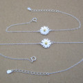 Dainty sunflower bracelet with a yellow gold-coloured centre on a silver chain