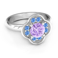 Blossoming Love flower-shaped engagement ring with round centre stone and accent stones