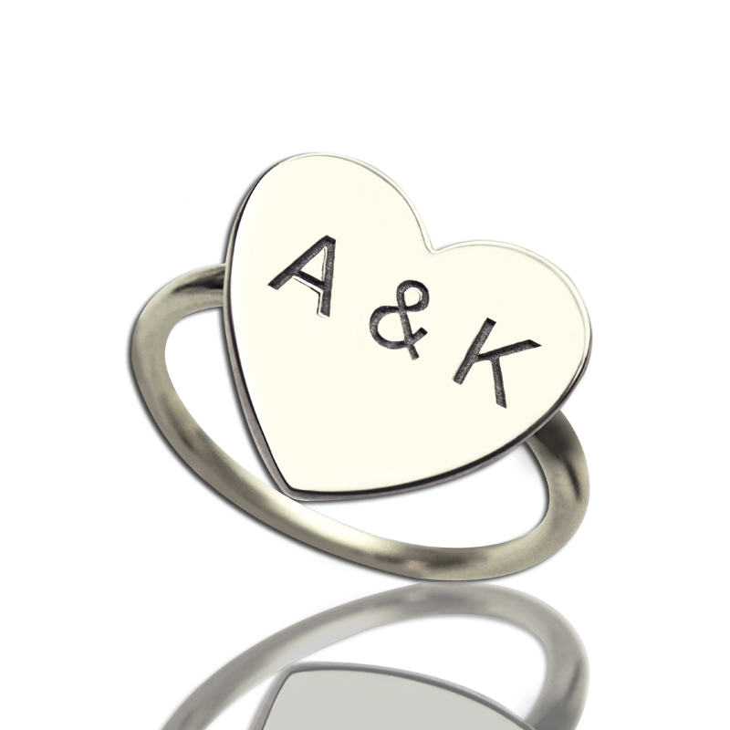 Engraved sweetheart ring with two initials joined by an ampersand