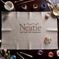 Neatie Heart Pendants Displayed On Velvet With Magnifying Glass