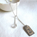 Fine silver label tag on lariat necklace