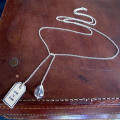 Close view of fine silver lariat label tag